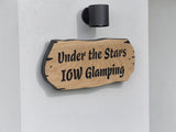 Personalised oak house sign mounted on white exterior wall with modern black light above