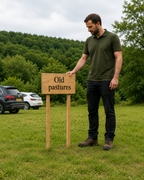 Wooden ground stake sign shown beside an adult for size comparison