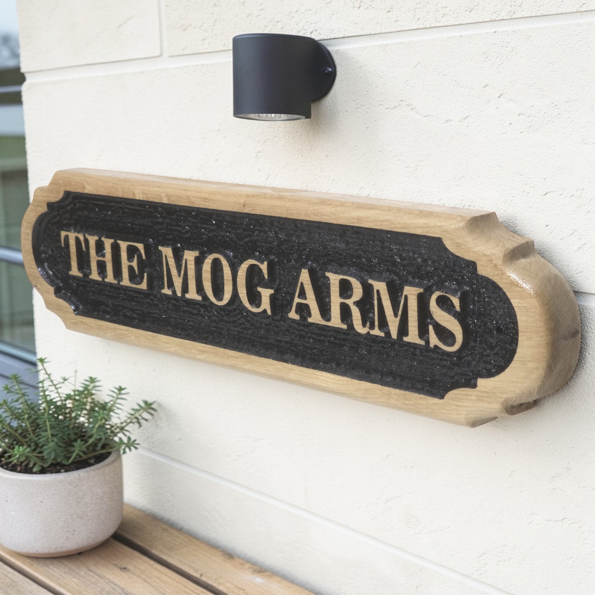 Oak house name plaque mounted beside front door
