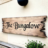 Rustic house address sign mounted under outdoor wall light