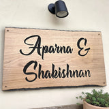 Custom family name oak house sign mounted on exterior wall