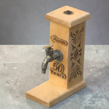 Custom oak drink dispenser stand with engraved design and metal tap