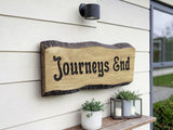 Bespoke solid oak house name sign handmade in UK mounted on modern exterior wall with outdoor light