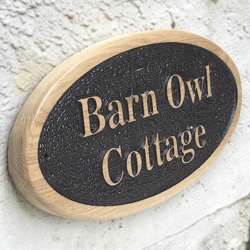 Personalised oval solid oak house sign mounted on exterior wall