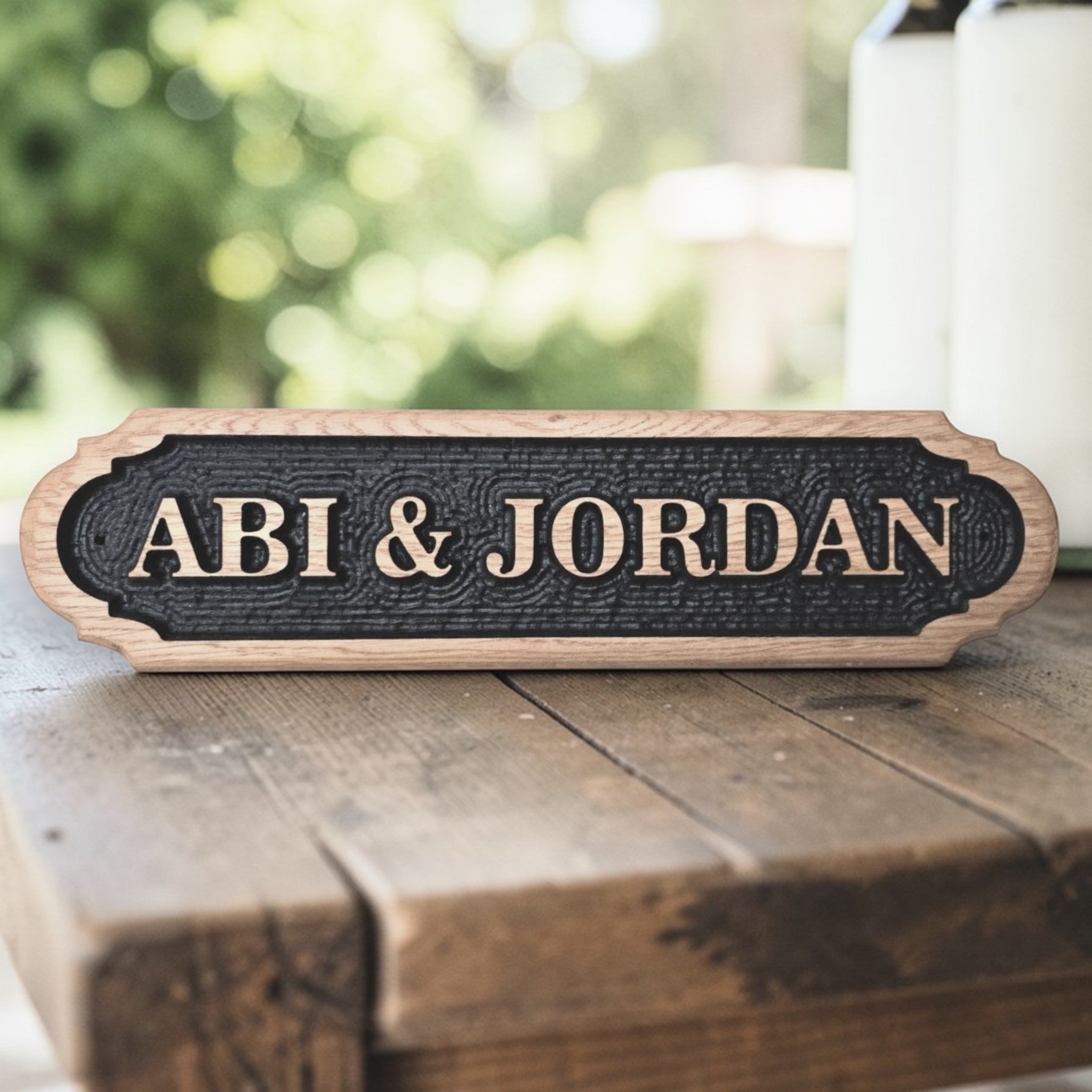 Personalised oak wedding or couple name sign on wooden surface