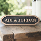 Personalised oak wedding or couple name sign on wooden surface