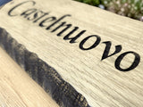 Deep engraved solid oak house sign close up showing natural wood grain detail