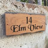 Elm View rustic oak house sign mounted on concrete wall