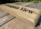 Close up of deep engraved lettering on oak name plaque