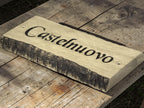 Bark edges oak house name sign displayed on rustic wooden table lifestyle photography UK