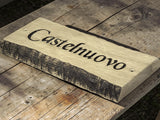Bark edges oak house name sign displayed on rustic wooden table lifestyle photography UK