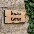 Engraved solid oak cottage name sign fixed to a stone wall with pre-drilled fixing holes
