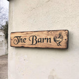 Personalised oak barn sign with engraved rooster mounted on exterior wall