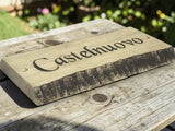 Handcrafted oak house name sign displayed on rustic wooden table lifestyle photography UK