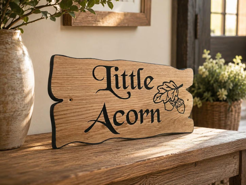 Personalised solid oak cottage sign with decorative engraving displayed indoors