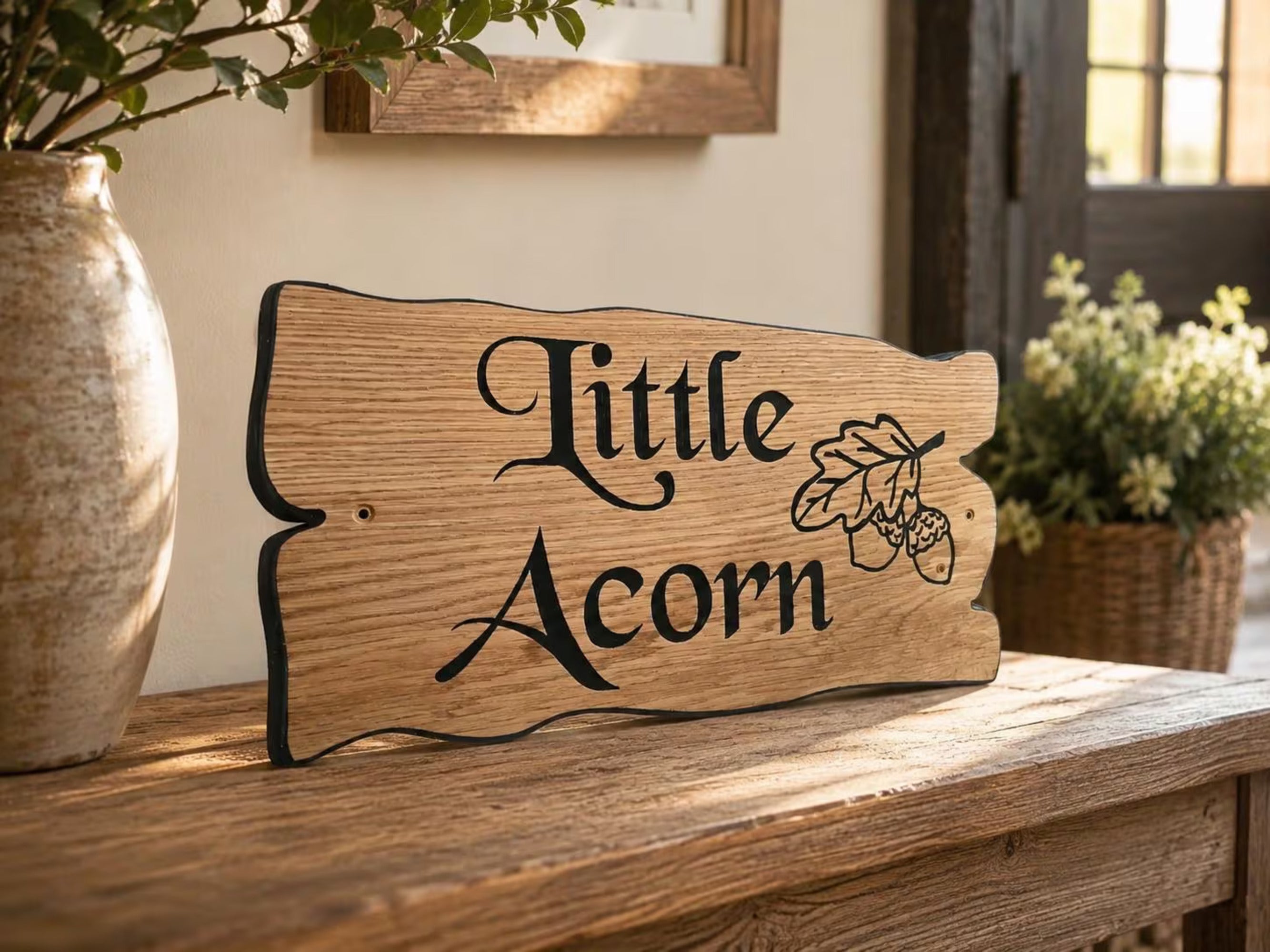 Personalised solid oak cottage sign with decorative engraving displayed indoors