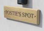Side angle view of engraved oak address sign