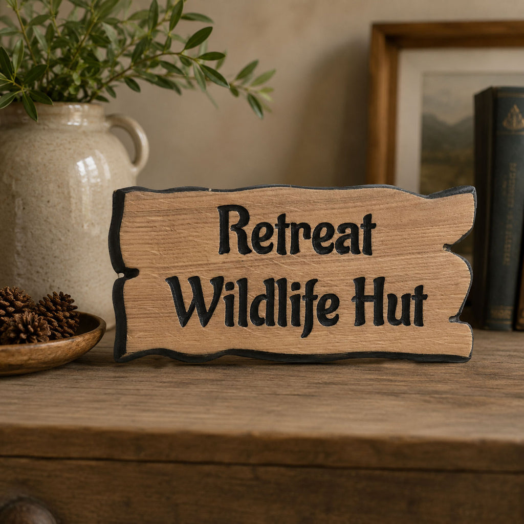 Personalised wooden cottage sign displayed on a rustic wooden shelf inside a country home