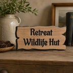 Personalised wooden cottage sign displayed on a rustic wooden shelf inside a country home