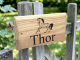 Custom engraved oak stable name sign mounted on wooden garden fence