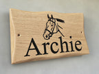 Side view of handcrafted oak animal name plaque showing wood grain detail