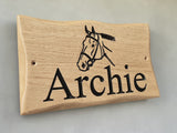 Side view of handcrafted oak animal name plaque showing wood grain detail