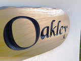 Close up detail of engraved oak house sign lettering Oakley