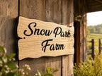 Angled view of personalised wooden cottage sign mounted on a rustic timber building
