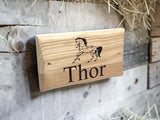 Personalised oak horse name sign mounted on stable door outdoor setting